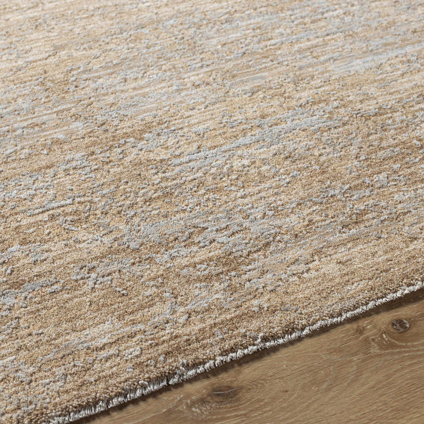 Close-up of the tan Jehan Area Rug showing its textured, machine-woven design and neutral color palette. Texture