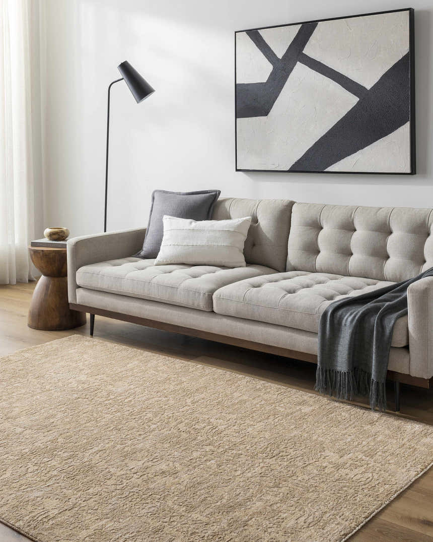 Living room scene with a tan sofa, abstract art, and the Katia Tan Area Rug. Roomscene-Rectangle