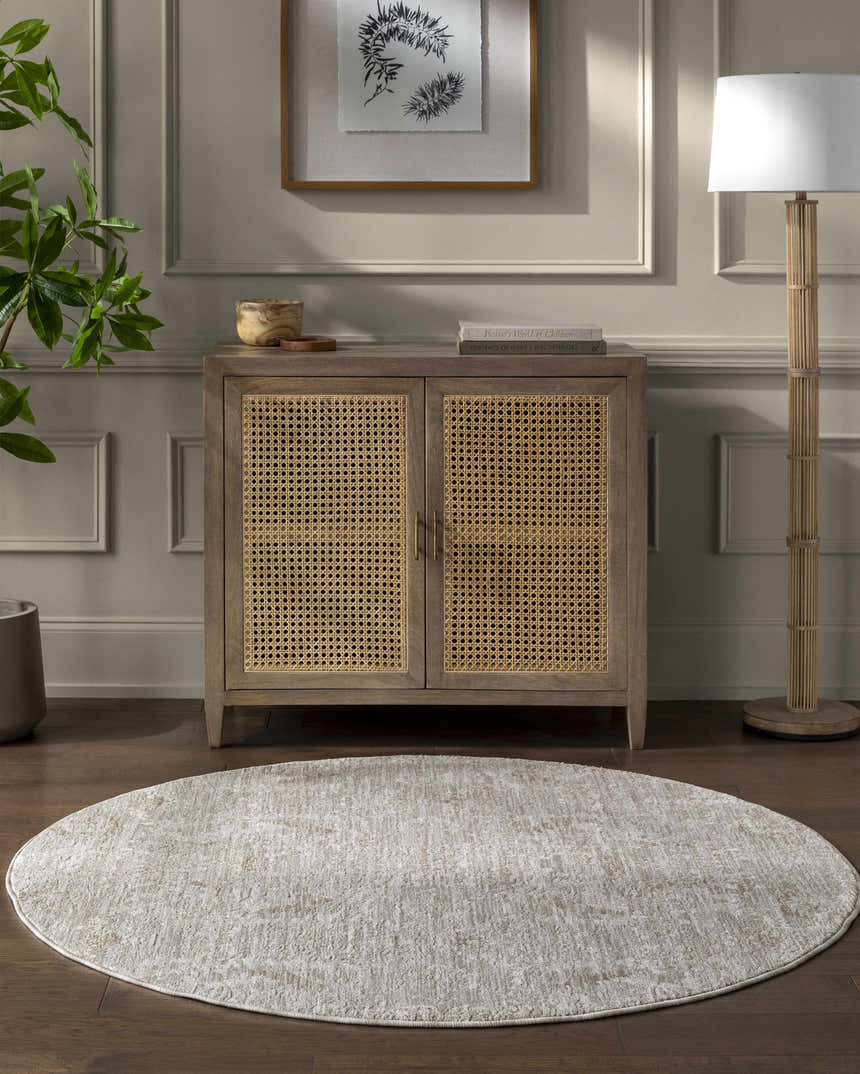 Living room scene with light gray Katia area rug, wood cabinet, and floor lamp. Roomscene-Round