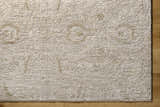 Close-up of the light gray and natural gray Katia Area Rug showing the textured, machine-woven design. Corner