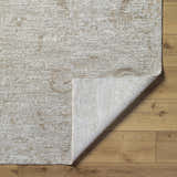 Close-up of the light gray and natural gray Katia Area Rug showing its traditional pattern and woven texture. Fold