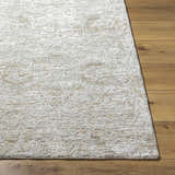 Close up of the light gray and natural gray Katia Area Rug on hardwood floor. Front