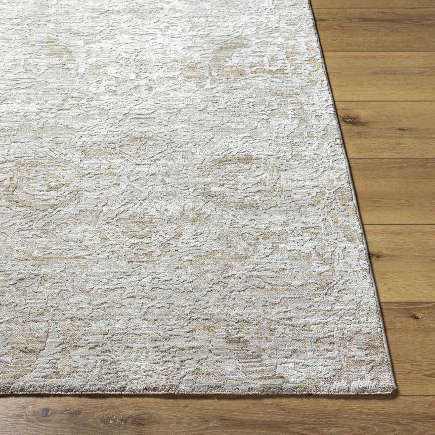 Close up of the light gray and natural gray Katia Area Rug on hardwood floor. Front