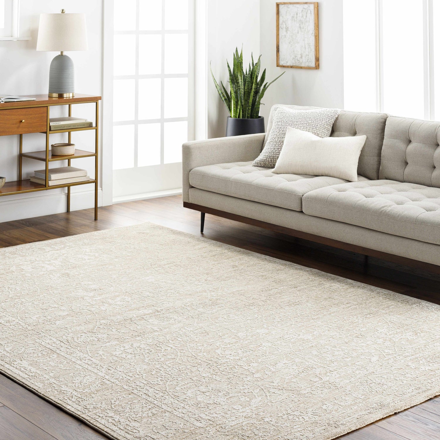 Living room with a light gray sofa and a light gray Kyran Area Rug with a traditional pattern. Roomscene-Rectangle