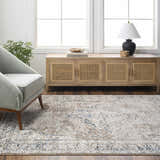 Living room scene with Jemma Brown Medallion Area Rug, gray chair, wood cabinet, and natural light from a large window. Roomscene-Rectangle