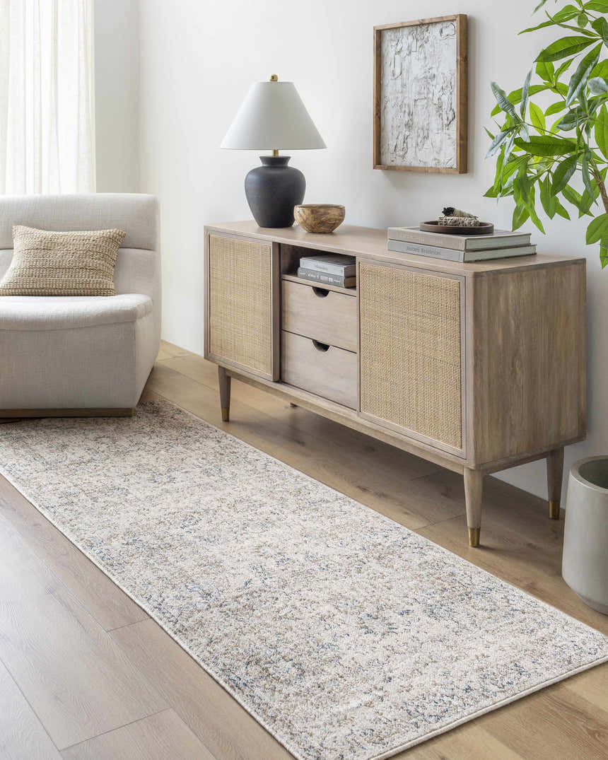 Living room scene with a Beachhouse Beige Keran Area Rug runner, light wood floors, and neutral furniture. Roomscene-Runner
