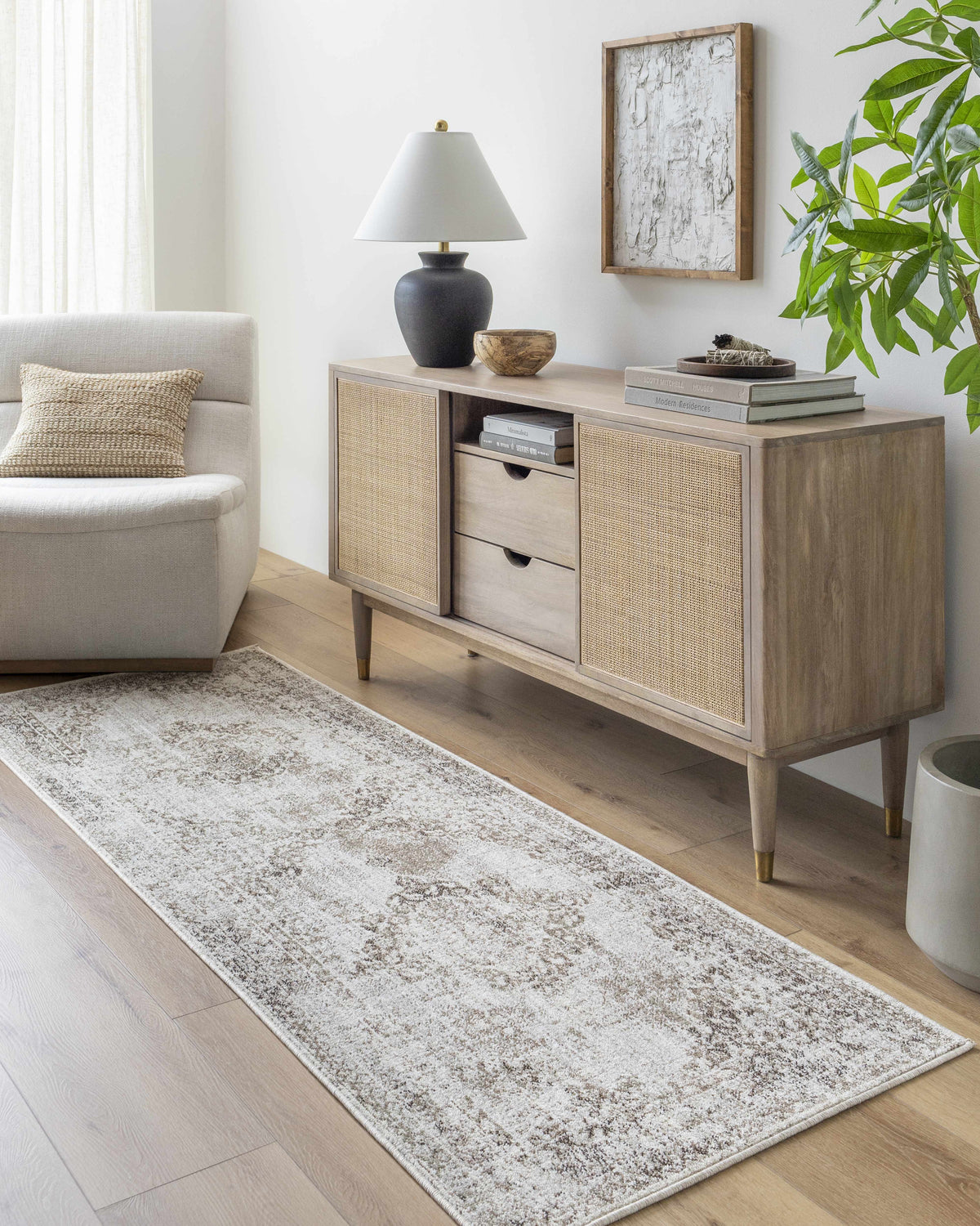 Living room scene with Kosta Beige Medallion Area Rug, light wood floors, console table, and neutral armchair. Roomscene-Runner