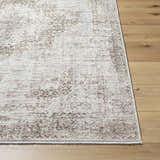 Close-up of the Kosta Beige Medallion Area Rug showing its lambswool and light brown traditional design on wood floors. Front