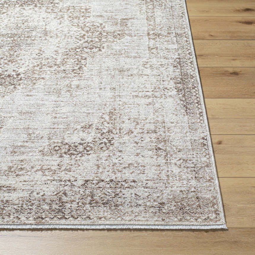 Close-up of the Kosta Beige Medallion Area Rug showing its lambswool and light brown traditional design on wood floors. Front