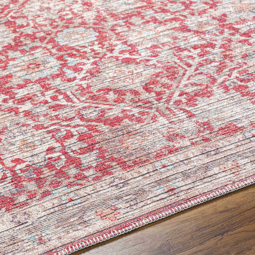 Close-up of the Cathy Area Rug in garnet. Farmhouse style rug with traditional floral pattern and textured weave. Texture