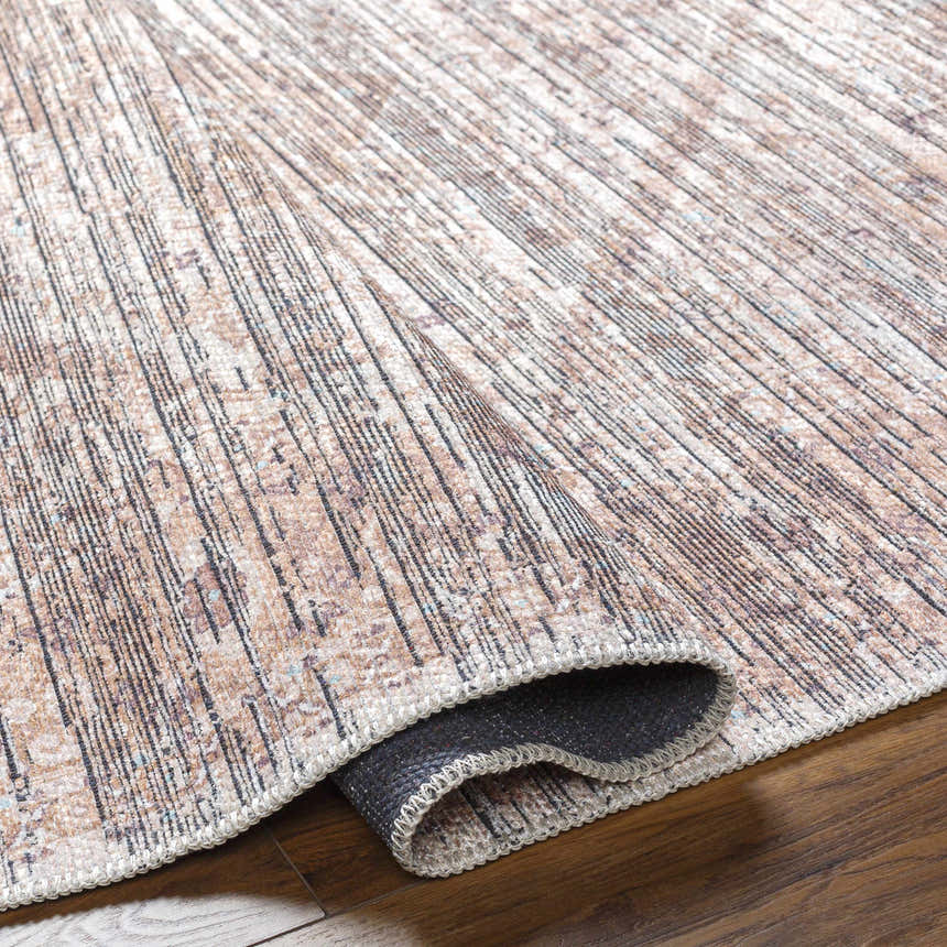 Close-up of the Elisa Area Rug showing its taupe, brown, and black farmhouse-style linear pattern and machine-woven texture. Fold
