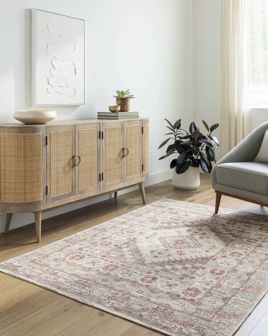 Living room scene with a neutral Liam Area Rug, wood cabinet, artwork, and gray chair. Farmhouse style. Roomscene-Rectangle