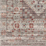 Close-up of the Liam Area Rug in Beachhouse: a traditional, machine-woven rug with red, brown, and gray floral and geometric patterns. Swatch