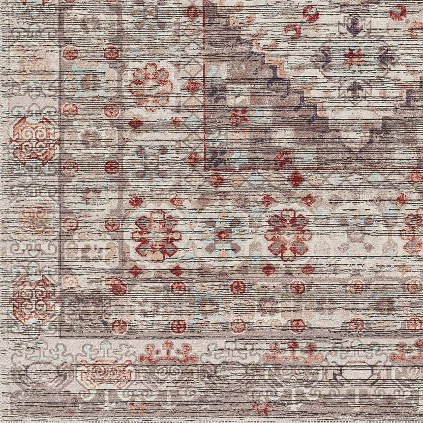 Close-up of the Liam Area Rug in Beachhouse: a traditional, machine-woven rug with red, brown, and gray floral and geometric patterns. Swatch