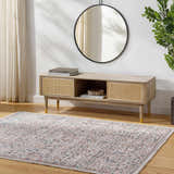 Living room scene with a Vulk Area Rug in aqua, burgundy, and gray, styled under a wood media console with a round mirror. Roomscene-Rectangle