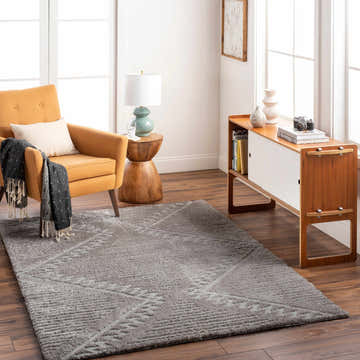 Living room scene with a gray Edsel Area Rug, mustard chair, and mid-century modern cabinet. Roomscene-Rectangle