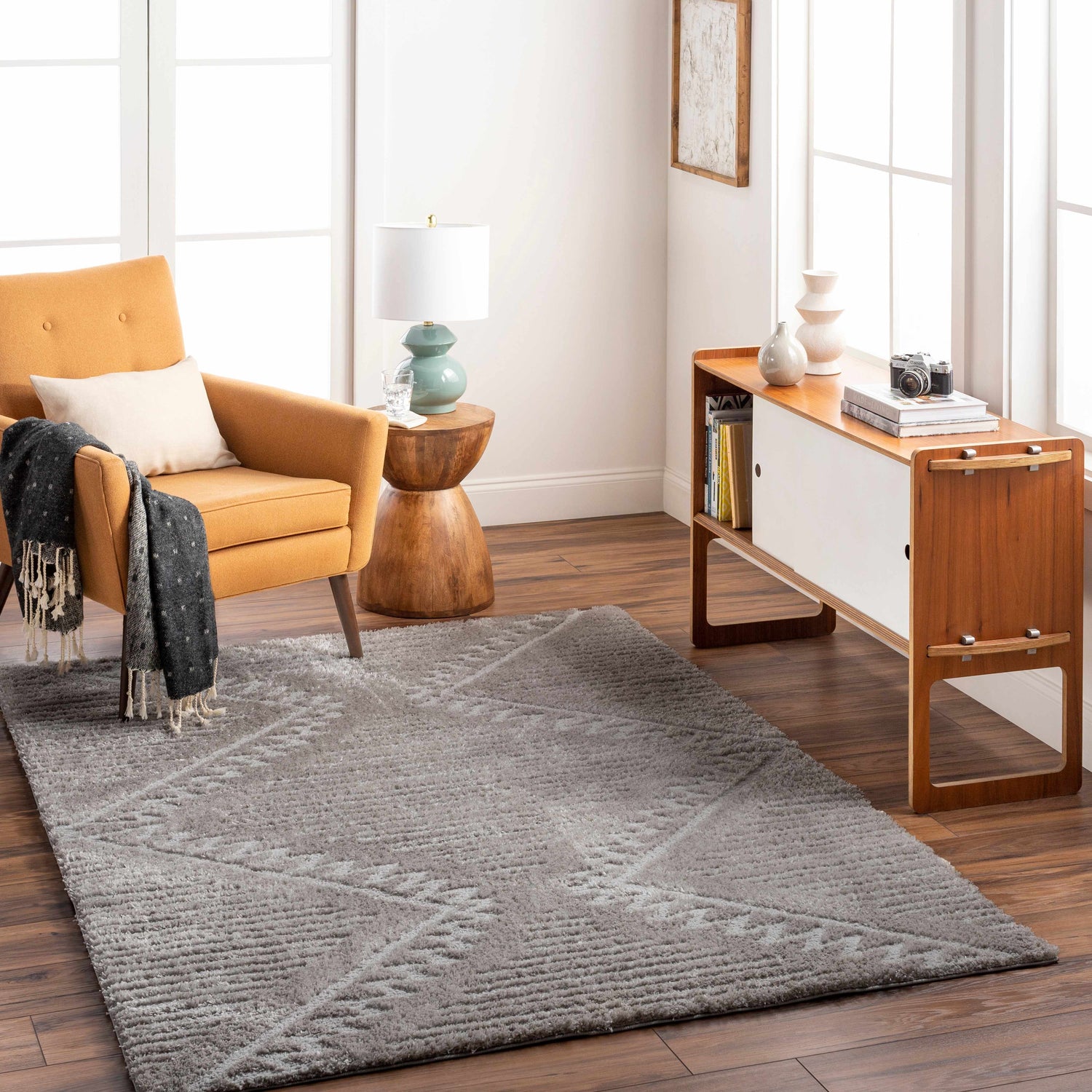 Living room scene with a gray Edsel Area Rug, mustard chair, and mid-century modern cabinet. Roomscene-Rectangle