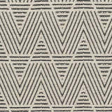 Close-up of the Dawid Wool Area Rug showing its black and bone geometric, hand-woven design and textured wool feel. Swatch