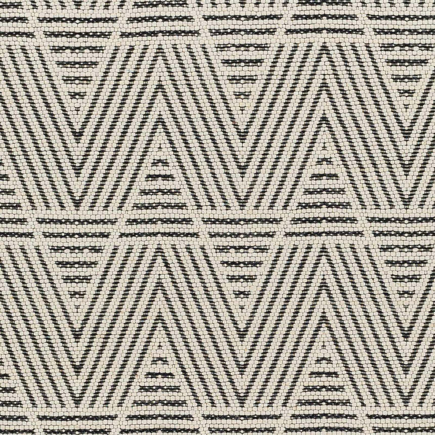 Close-up of the Dawid Wool Area Rug showing its black and bone geometric, hand-woven design and textured wool feel. Swatch