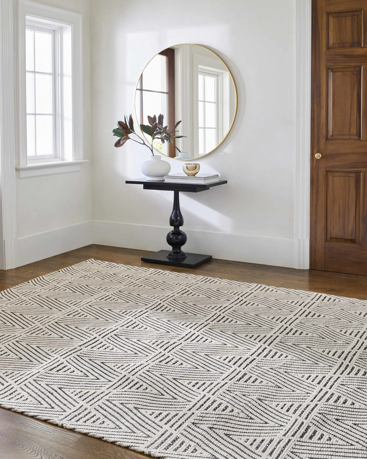 Entryway with a black accent table and the Dawid Wool Area Rug in black and bone. Roomscene-Rectangle