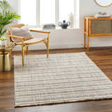 Living room scene with a striped beige Avari Area Rug, wood floors, chair, and cabinet. Roomscene-Rectangle