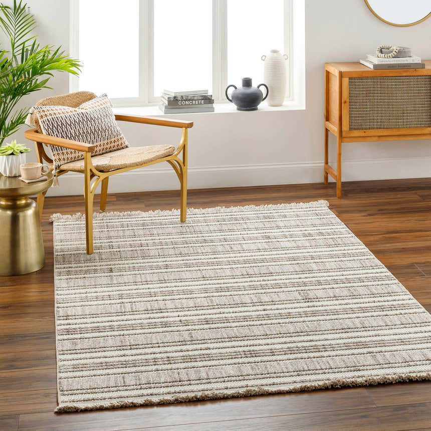 Living room scene with a striped beige Avari Area Rug, wood floors, chair, and cabinet. Roomscene-Rectangle