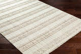 Close-up of Dagan Area Rug: beige and driftwood tones, striped geometric pattern, machine woven texture. Corner