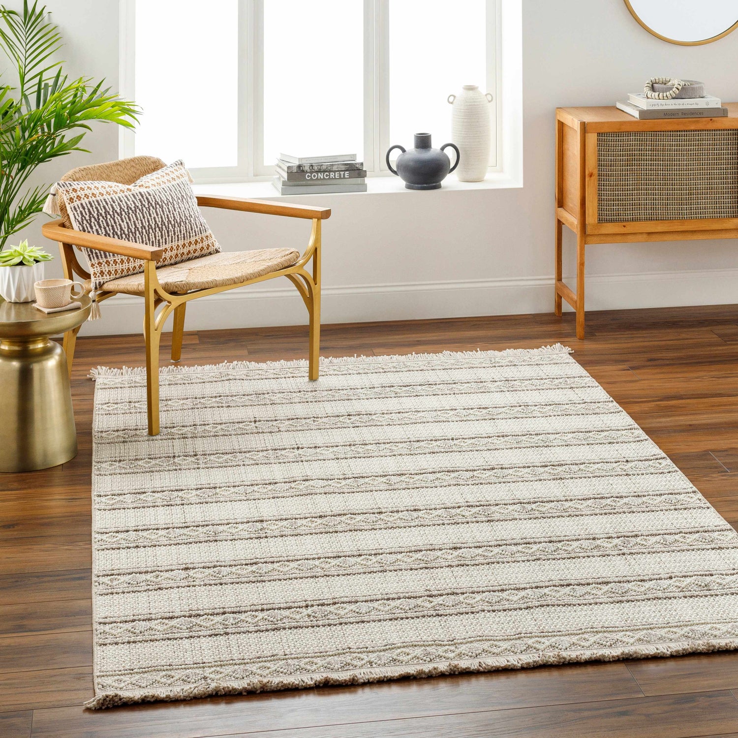 Living room scene with a beige Dagan Area Rug, wood floors, and a woven chair near a sunny window. Roomscene-Rectangle