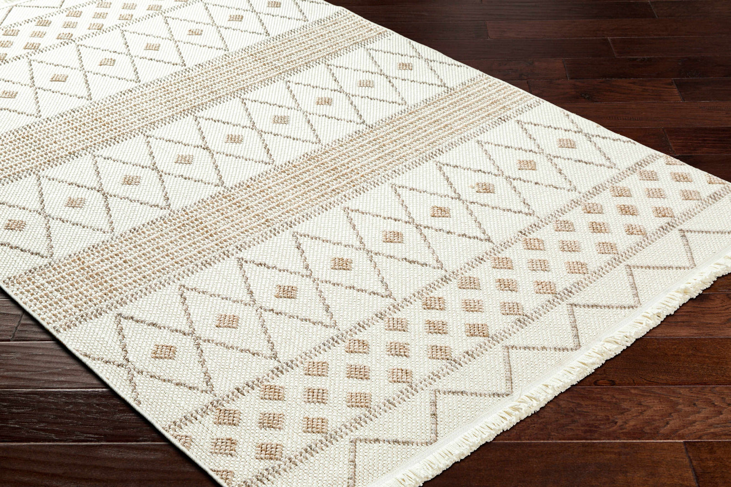 Close-up of the Finch Area Rug. Beige and brown geometric pattern on a cream background. Farmhouse style. Corner