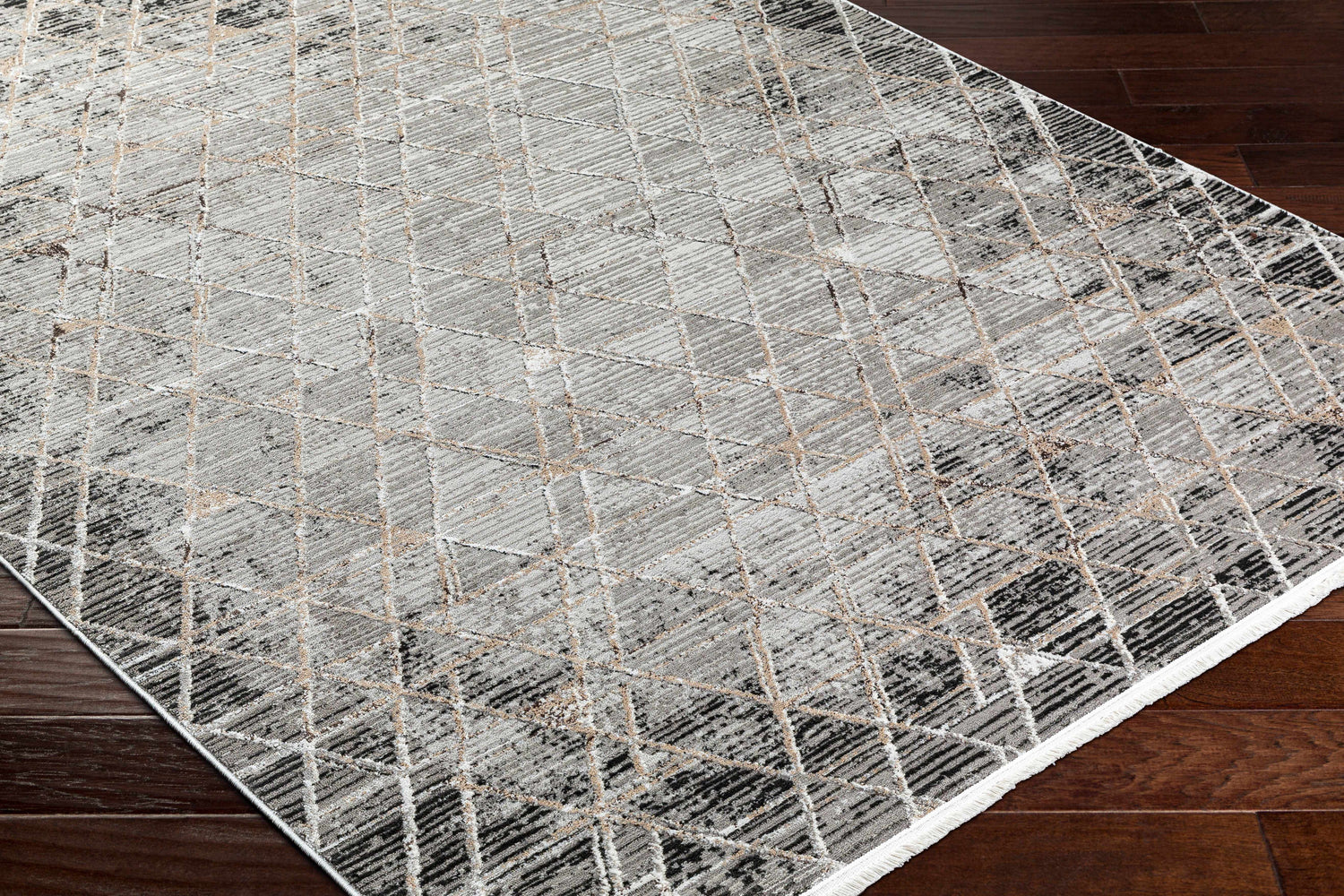 Close-up of Luol Gray Area Rug showing charcoal, gray, and natural geometric pattern and soft polyester texture. Corner