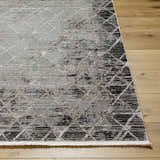 Close-up of the Luol Gray Area Rug showing its charcoal, gray, and tan diamond pattern on wood flooring. Front