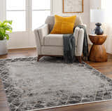 Living room scene with Luol Gray Area Rug, gray armchair, yellow pillow, and wood side table. Roomscene-Rectangle