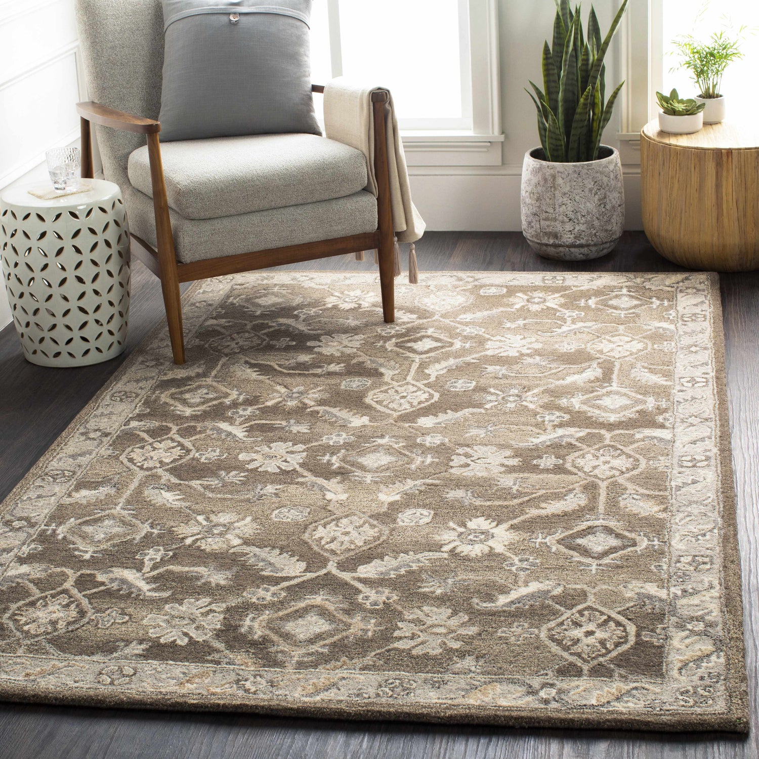 Living room scene with a brown Solen Area Rug, gray armchair, and plants. Neutral, cozy decor. Roomscene-Rectangle