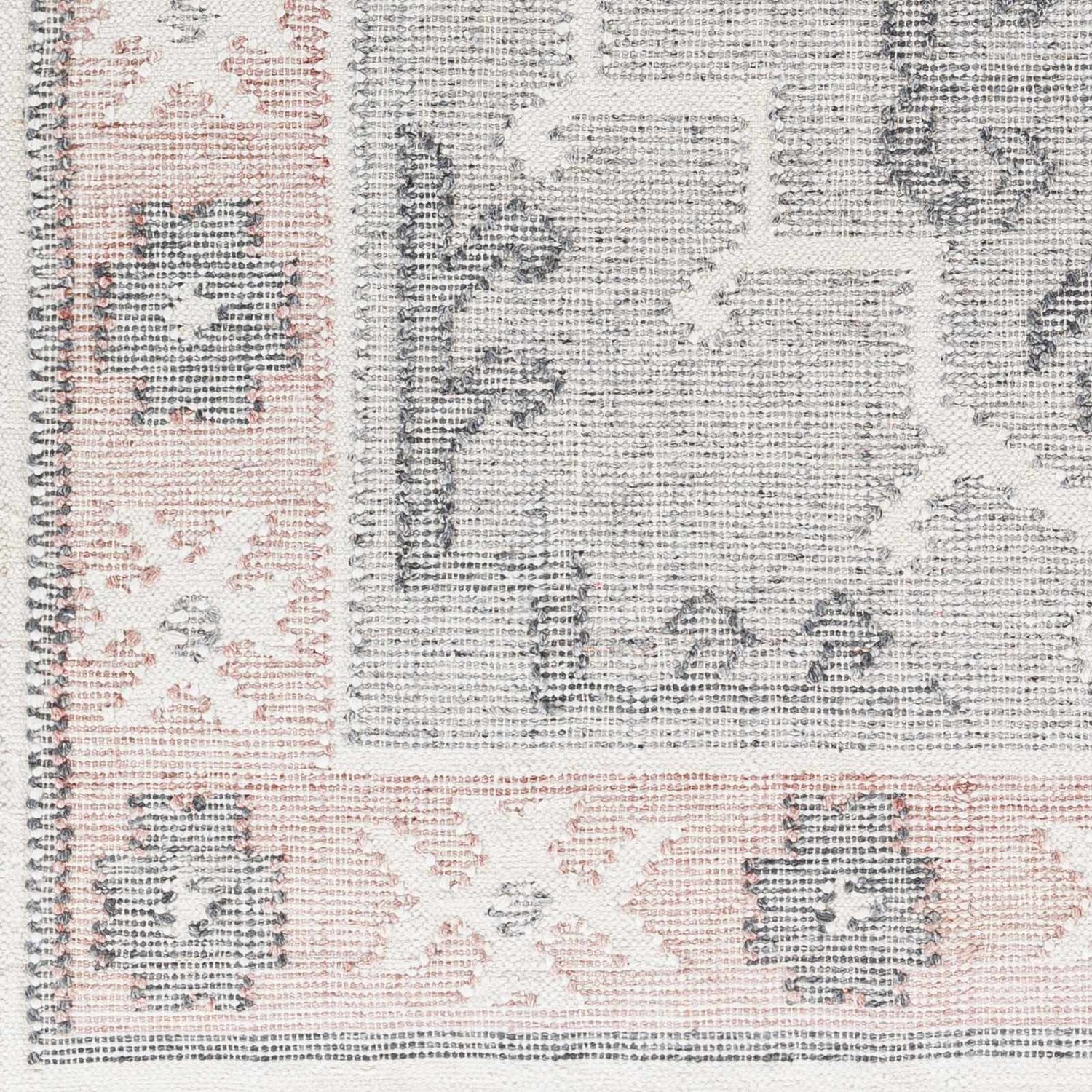 Close-up of hand-woven Sosa Area Rug. Charcoal, cream, and dusty pink traditional pattern. Recycled PET yarn texture. Swatch