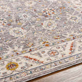 Close-up of the Sosi Area Carpet showing its dark beige, garnet, and gray traditional floral pattern and soft texture. Texture