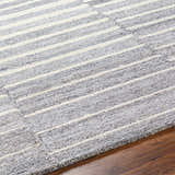 Close-up of Gawel Gray Area Rug showing its textured gray and cream striped, contemporary design. Texture