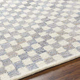 Close-up of the Halen Gray Checkered Area Rug showing its geometric, textured, charcoal and light gray checkered pattern. Texture