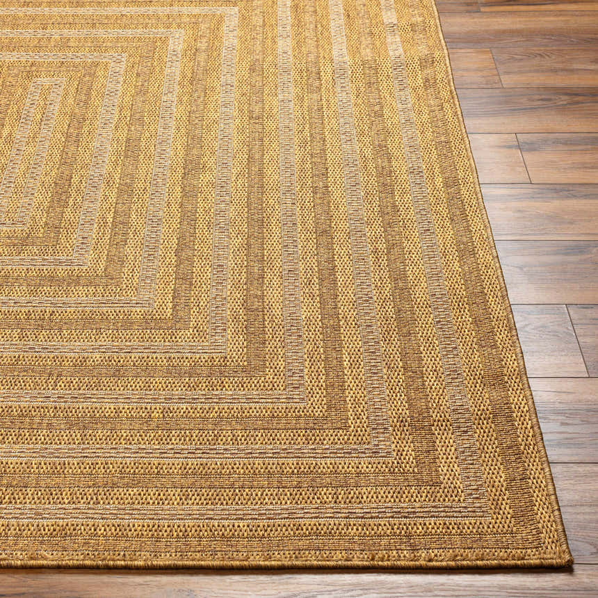 Close-up of the Dyami Flatweave Faux Jute Rug. Camel and light brown tones with a geometric striped pattern. Front