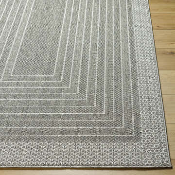 Close up of the Mopsa Nickel Area Rug showing gray and nickel geometric pattern and woven texture. Front