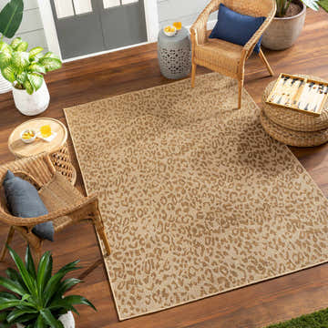 Outdoor patio scene with wicker chairs and a beige Prem Flatweave Faux Jute Rug with a subtle animal print. Roomscene-Rectangle