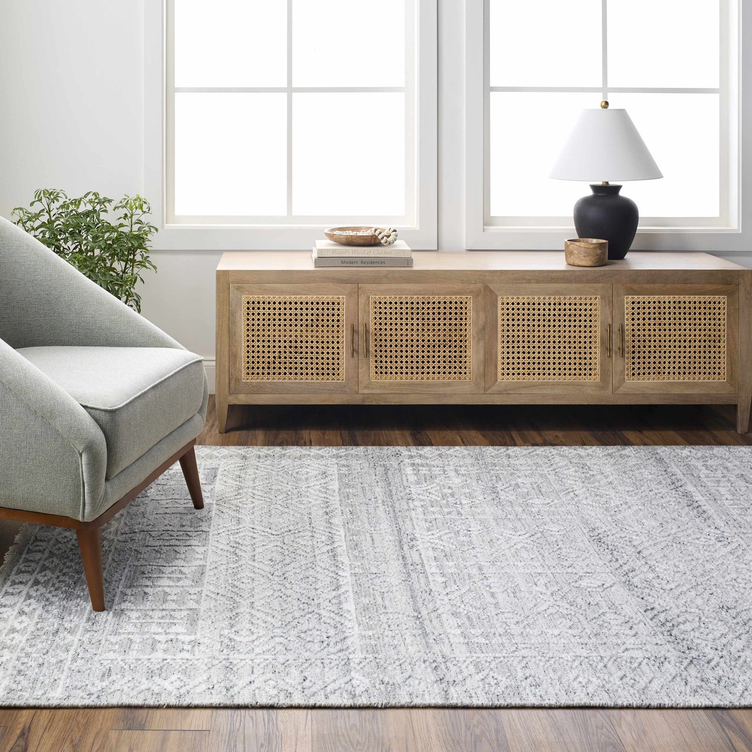 Living room scene with gray Kazi Area Rug, light wood console table, gray armchair, and natural light. Scandinavian style. Roomscene-Rectangle