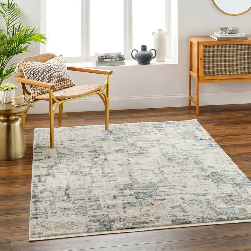 Living room scene with the Hyeon Area Carpet, featuring a chair, side table, and wooden cabinet. Neutral, contemporary style. Roomscene-Rectangle