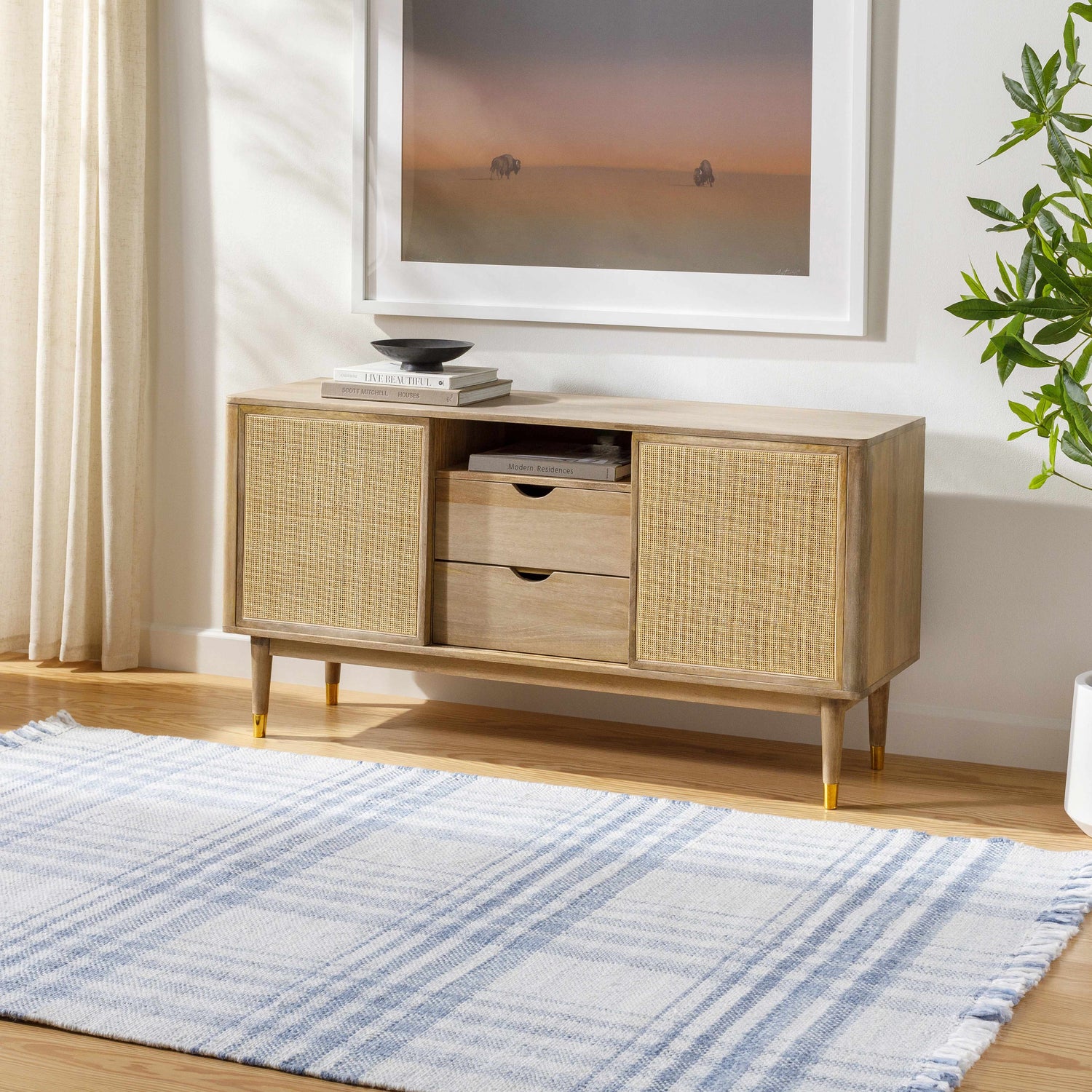 Living room scene with Inara Blue Plaid Area Rug, light wood console table, artwork, and plant. Farmhouse style. Roomscene-Rectangle