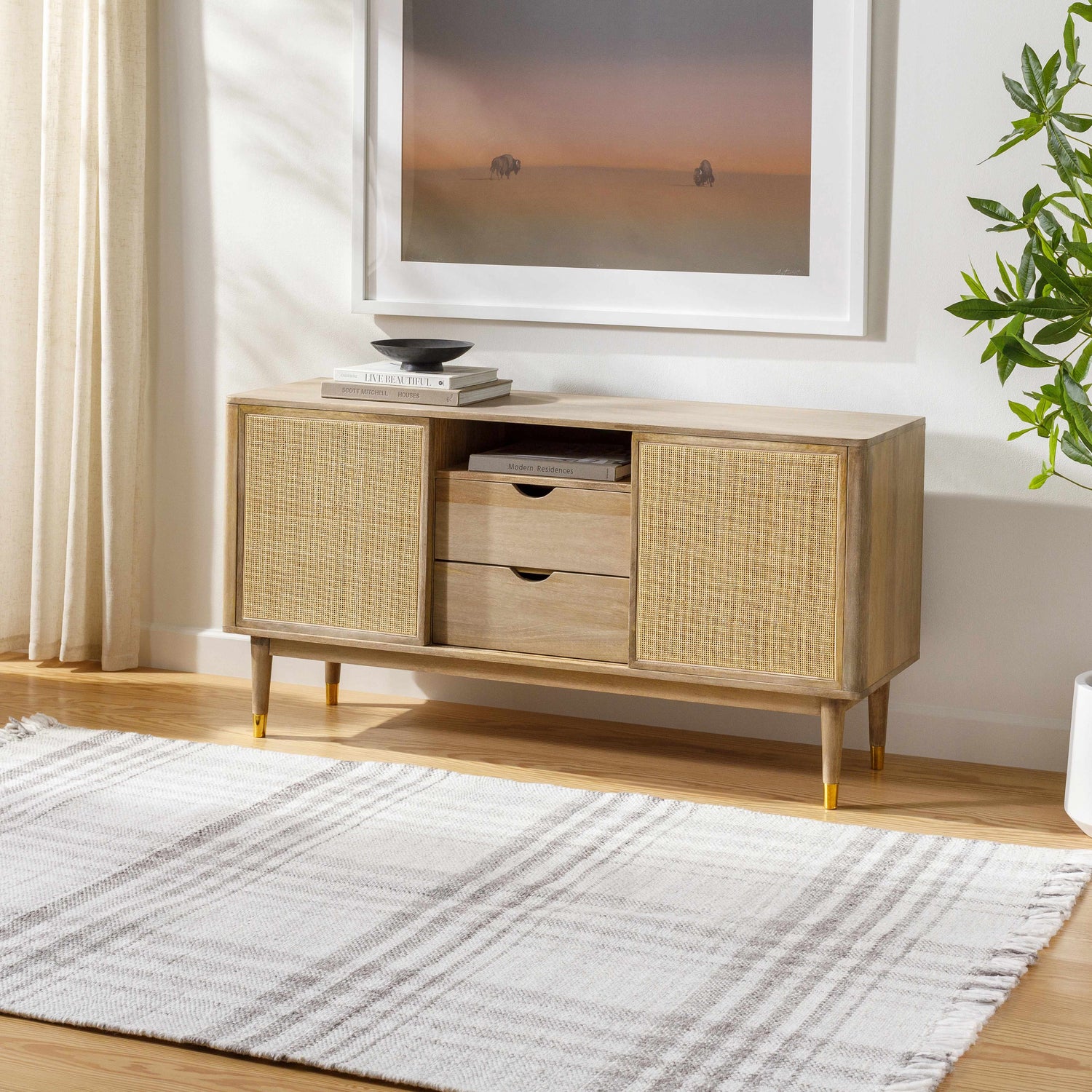Living room scene with a gray Inara Plaid Area Rug under a wood and cane console table. Roomscene-Rectangle
