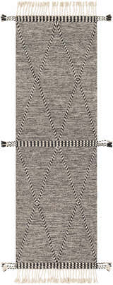 Close-up of Spottswood Area Rug. Black and cream cotton rug with diamond pattern and fringe. Bohemian farmhouse style. Design-Runner-268