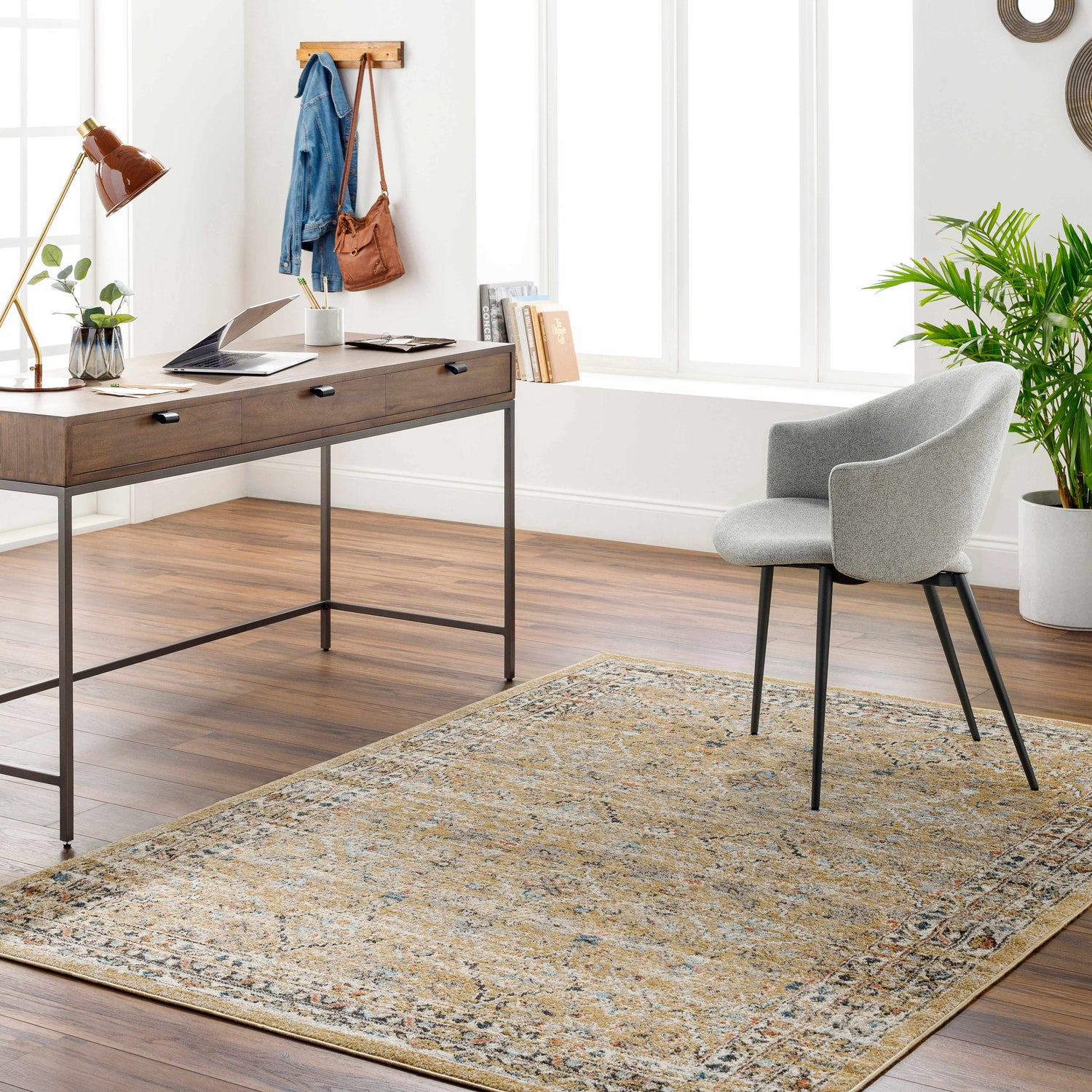 Home office with Ares Light Beige Area Rug, wood desk, gray chair, and wood floors. Roomscene-Rectangle