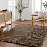 Living room scene with a Riki Black Area Rug, wood cabinet, chair, and natural light. Scandinavian style. Roomscene-Rectangle