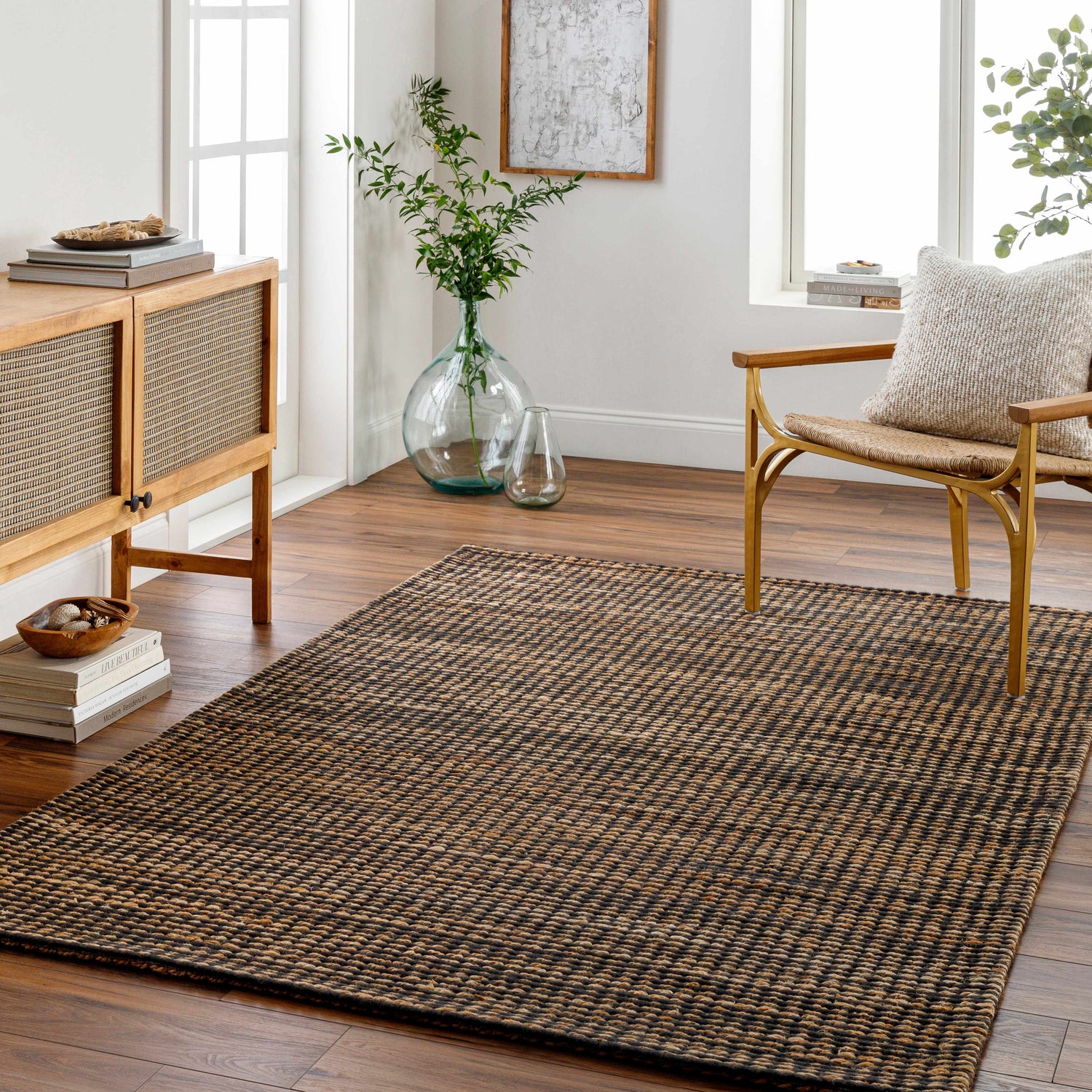 Living room scene with a Riki Black Area Rug, wood cabinet, chair, and natural light. Scandinavian style. Roomscene-Rectangle