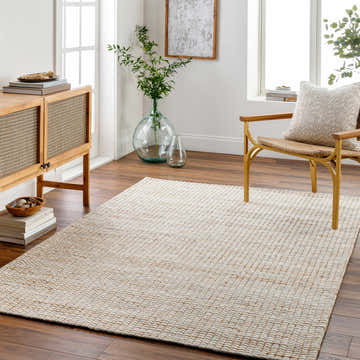 Scandinavian-style living room with a Riki Cream Jute-Wool Blend Rug, wood cabinet, and chair. Neutral tones create a calming atmosphere. Roomscene-Rectangle