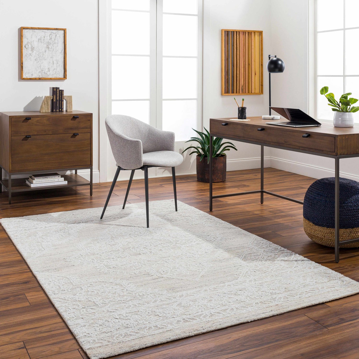 Home office with wood floors and Denae Cream Area Rug. Desk, chair, dresser, and natural light create a calm, productive space. Roomscene-Rectangle